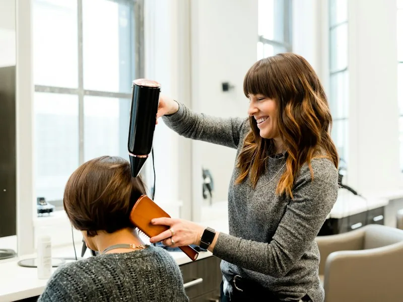 A stylist working with a client in a salon.